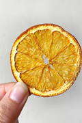 Dried orange slices in a jar from Citrus Huis, 80g, showcasing vibrant orange color and textured surface, perfect for snacks or decoration.